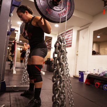 A Lifters Guild lifter squatting with chains