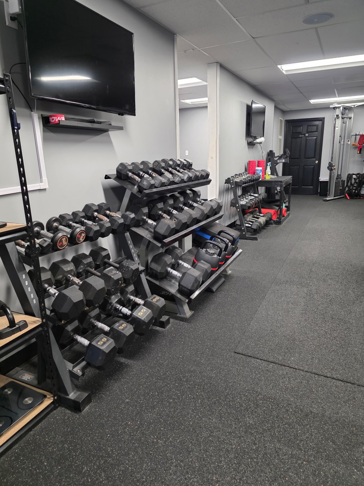 Dumbbell and accessory area at The Studio