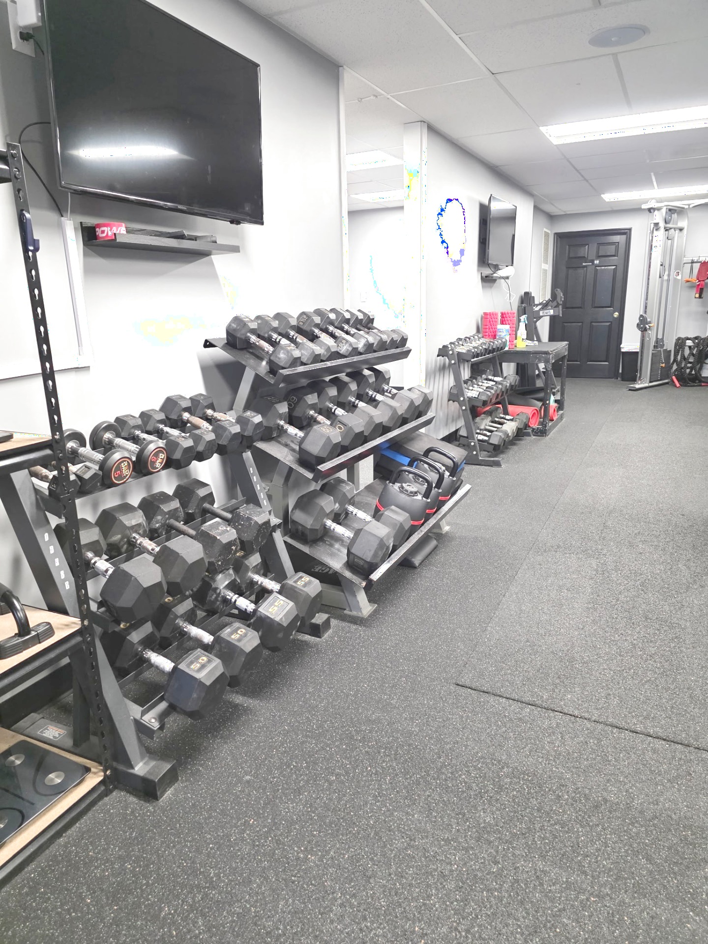 Dumbbell and accessory area at The Studio